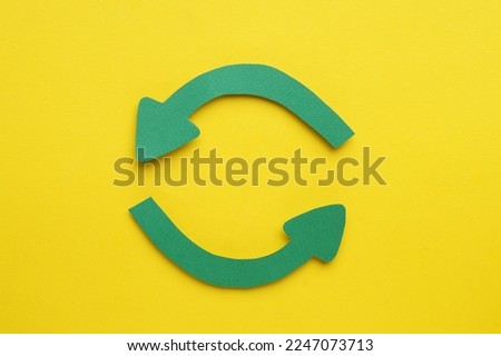 Paper curved arrows on yellow background, flat lay. Space for text Royalty-Free Stock Photo #2247073713