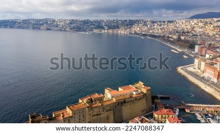 Aerial view of the Caracciolo waterfront and Castel dell'Ovo, a seafront castle located in Naples, Italy. Royalty-Free Stock Photo #2247088347