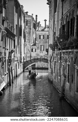 Canal in Venice with gondola. Black and white photography