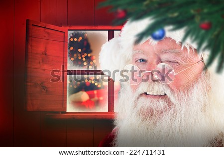 Santa claus winking against christmas at home