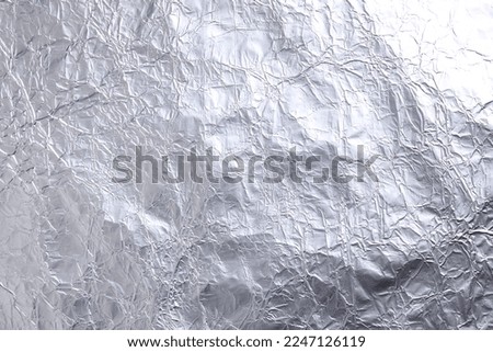 Crumpled silver foil as background, closeup view Royalty-Free Stock Photo #2247126119