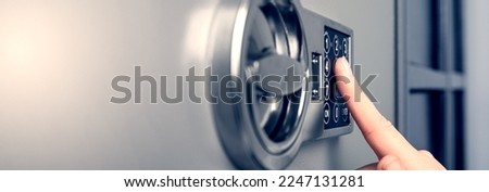 Woman opening steel safe with electronic lock, closeup. Banner design Royalty-Free Stock Photo #2247131281