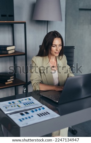 Business woman working with laptop at her desk Royalty-Free Stock Photo #2247134947