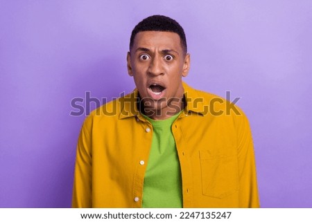 Photo portrait of attractive young male astonished mad face expression wear trendy yellow outfit isolated on purple color background Royalty-Free Stock Photo #2247135247