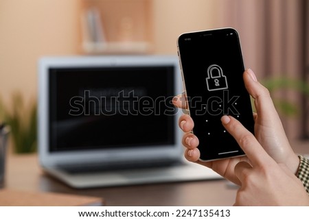 Woman unlocking smartphone with blocked screen indoors, closeup. Space for text