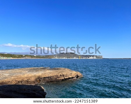 a strange rock cliff near the blue sea