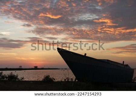 BARRU DISTRICT, SOUTH SULAWESI, INDONESIA- 14 September 2017: A traditional boat with sea and sunset in the background. This traditional boat is usually called katinting by local people.