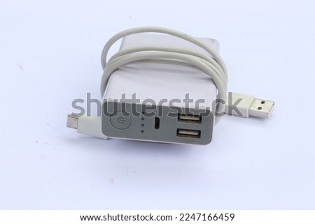 Portable powerbank with usb cable on white background. Top view