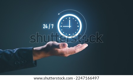 nonstop service concept. businessman hand holding virtual 24-7 with clock on hand for worldwide nonstop and full-time available contact of service concept. customer service. Royalty-Free Stock Photo #2247166497