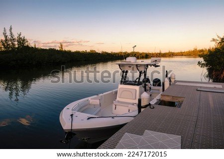 A small boat moored in a quiet corner of South Bimini, Bahamas Royalty-Free Stock Photo #2247172015
