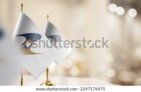 Small flags of the Eurasian Economic Union on an abstract blurry background. Royalty-Free Stock Photo #2247176475