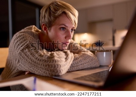 Young Woman Working Or Studying On Laptop At Home At Night Staring At Screen Royalty-Free Stock Photo #2247177211