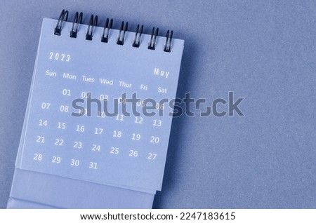 May 2023 Monthly desk calendar for 2023 year on blue background. Royalty-Free Stock Photo #2247183615
