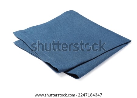 Blue folded fabric napkin on white background Royalty-Free Stock Photo #2247184347