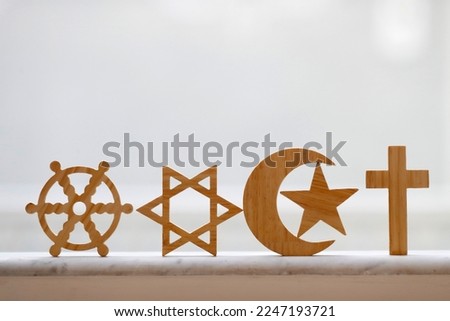 Wooden religious symbols :  Catholic, Islam, Judaism, Protestant, Buddhism and Hinduism. Interreligious, interfaith and spirituality concept. Royalty-Free Stock Photo #2247193721