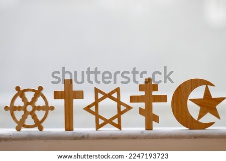 Wooden religious symbols :  Catholic, Islam, Judaism, Orthodox, Protestant, Buddhism and Hinduism. Interreligious, interfaith and spirituality concept. Royalty-Free Stock Photo #2247193723