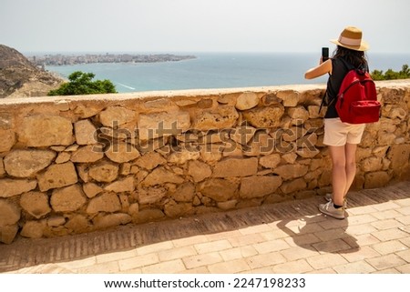 View from Santa Barbara Castle in Alicante with Caucasian girl taking pictures, Andalusia - Spain