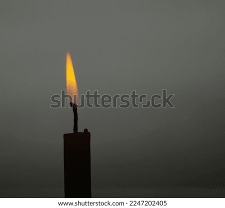 Candle burning with backlight in the background