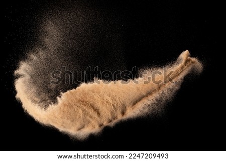 Small size fine Sand flying explosion, Golden grain wave explode. Abstract cloud fly. Yellow colored sand splash silica in Air. Element Black background Isolated high speed throwing freeze shot Royalty-Free Stock Photo #2247209493