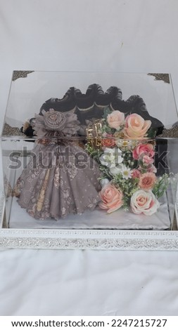Decorated flower bouquet in a hamper box. contain moslem woman prayer tools as a gift in Indonesia wedding.