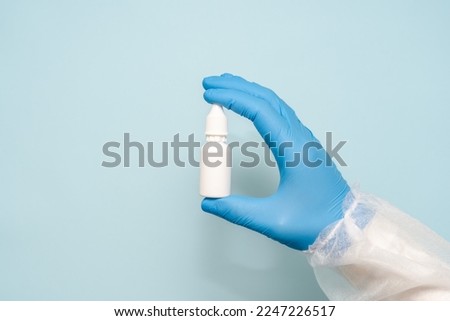 Doctors hand holding eye, ear or nose drops