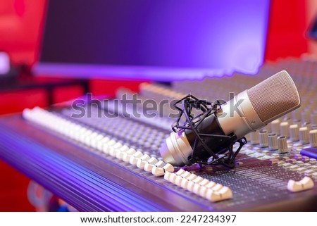 condenser microphone on audio mixing console in studio. recording concept