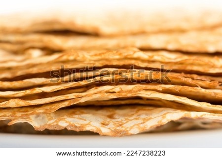 Close up on a stack of crepes (french pancakes), sweet dessert food abstract background