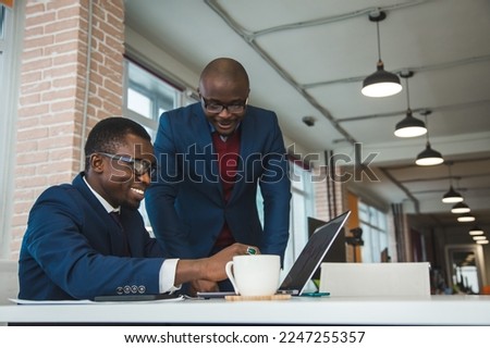 Two African American business partners are working on a laptop together on a joint project. Mutual assistance and establishment of social contacts Royalty-Free Stock Photo #2247255357