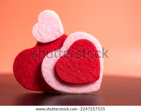 Heart of different colors on a pink background. Valentine's day concept.