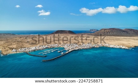 Panoramic view, aerial shot of La Graciosa, volcanic island surrounded by the Atlantic Ocean, photo taken from Lanzarote Island, Canary Islands of Spain. Travel destinations and tourism concept