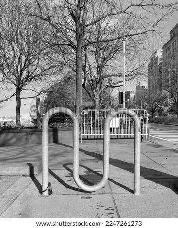 A Black and White picture of a bike rack.
