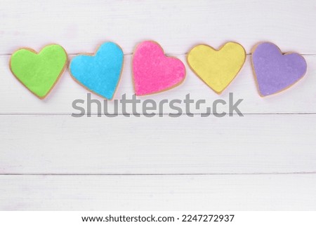 Homemade hearts shaped gingerbread cookies on wooden table