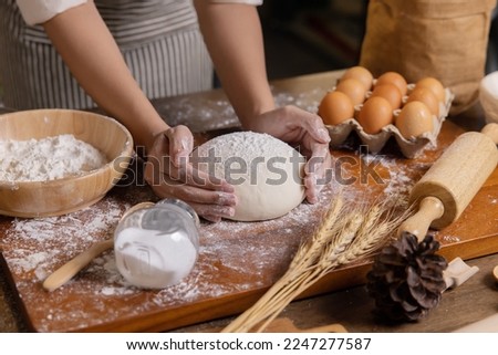 Woman Hands Prepare and Rest the Dough Before Putting the Dough into the Oven Royalty-Free Stock Photo #2247277587