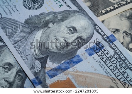 One hundred US dollar banknotes, portrait of Benjamin Franklin, macro shot with bokeh effect