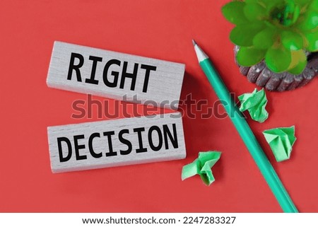 RIGHT DECISION - words on wooden bars on a red background with a handle, cactus and papers. Education concept