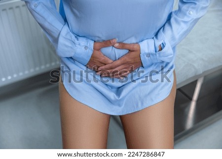Close up picture of a woman protecting her belly