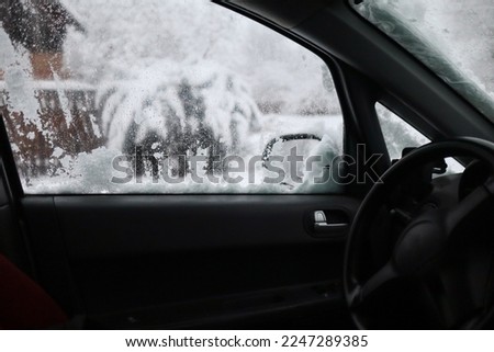 Winter outside the window.A lot of snow.
The interior of the auto.Automotive.Driving.Misted car glass.Bad weather. Snowfall.View from the car window.Dangerous road.