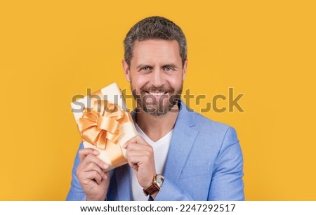 happy guy with gift box for holiday. photo of guy holding occasion gift box. guy hold gift box