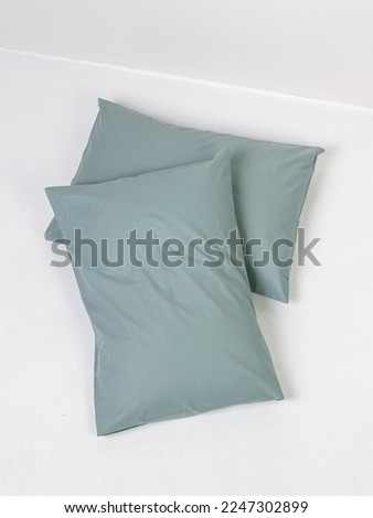 Two pillows in green pillowcases on white background Royalty-Free Stock Photo #2247302899