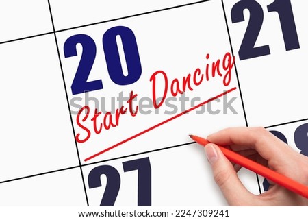 20th day of the month. Hand writing text START DANCING and drawing a line on calendar date. Save the date. Deadline. Business concept Day of the year concept.