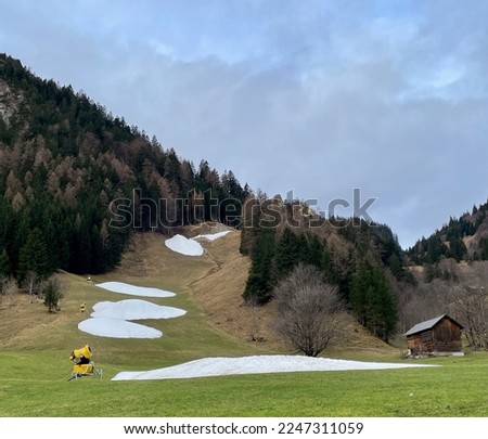 No snow on skiing slopes in winter due to climate change. . High quality photo Royalty-Free Stock Photo #2247311059