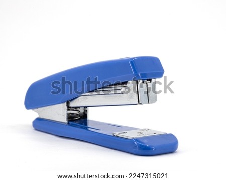 plastic stapler, blue stapler drawn on a white background. Selective focus, noise effect. Royalty-Free Stock Photo #2247315021