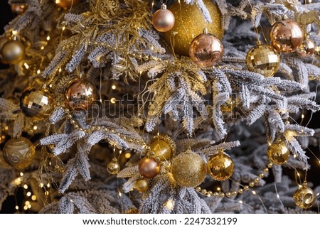Beautiful Christmas tree with garlands, balls and toys. Preparing your home for the new year