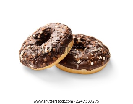Donuts in chocolate isolated. Sweet breakfast. Dessert. Junk food. Two chocolate donuts on a white background.