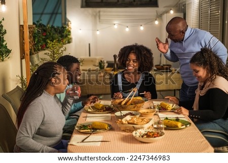 African family eating together on the terrace healthy food enjoying an evening together