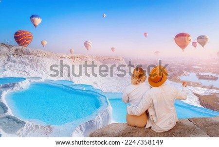 Concept Travel tourist background Pamukkale Turkey. Lover couple watching Hot air balloon flying Travertine pool and terraces. Royalty-Free Stock Photo #2247358149