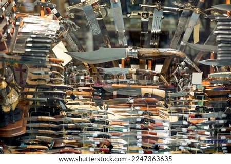 Diversity of handmade forged swords, daggers and knives for sale in gift shop of Toledo. Authentic tourist souvenirs. Royalty-Free Stock Photo #2247363635
