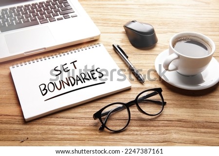 Set Boundaries, motivational words and sentences for work and life. Quote sentence in notebook with laptop, pen, coffee over wooden background.  Royalty-Free Stock Photo #2247387161