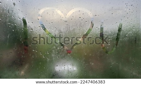 Blurred image, Romantic I love you written on fogged or frozen window glass, close up sign