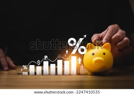 interest rates and dividends, investment returns, income, retirement Compensation fund, investment, dividend tax. pile of coins and upward direction percentage symbol. saving money for investment Royalty-Free Stock Photo #2247410535